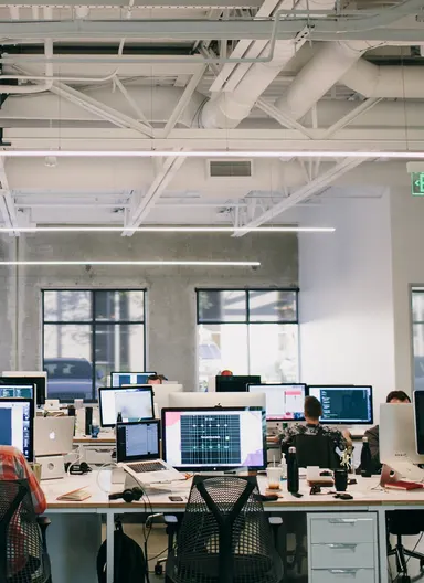 The open workspace, desks under the windows.